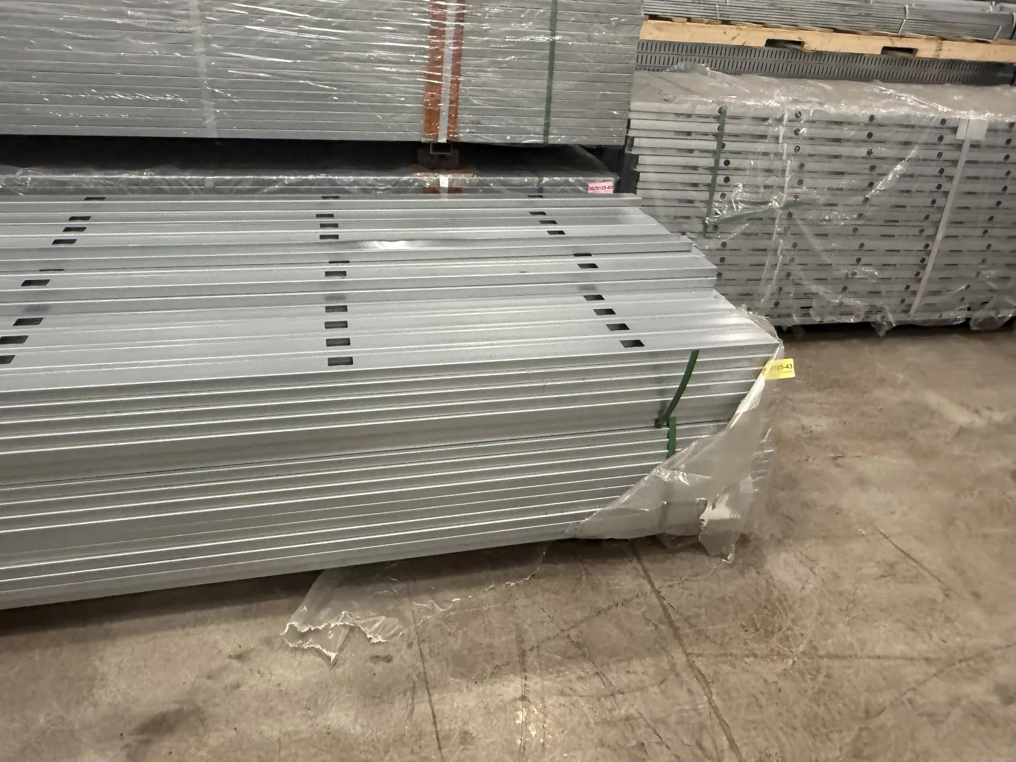 Bundle of galvanized steel studs with a handwritten 162S125 label